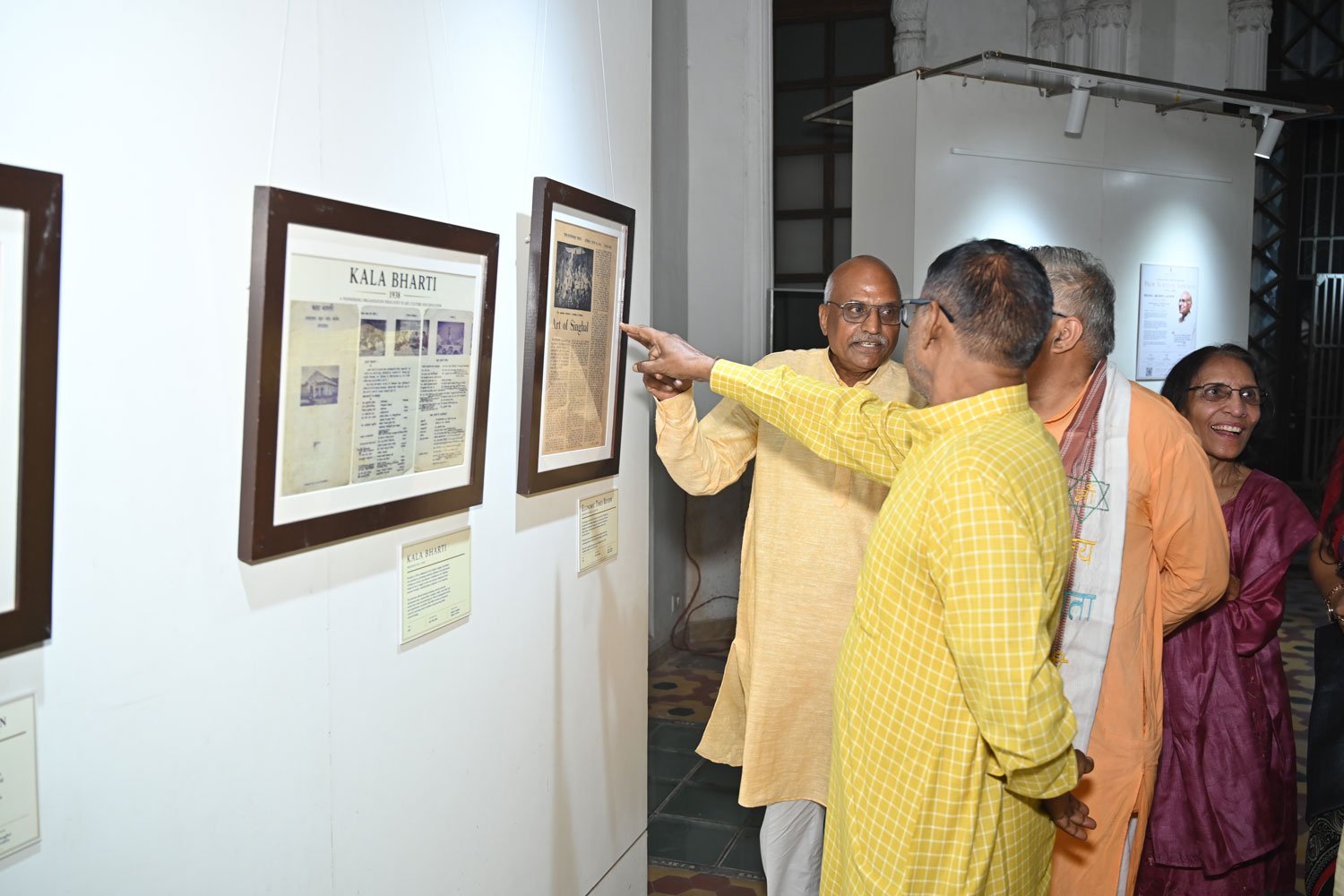 Guests viewing archival records and historical documents displayed as part of the exhibition.